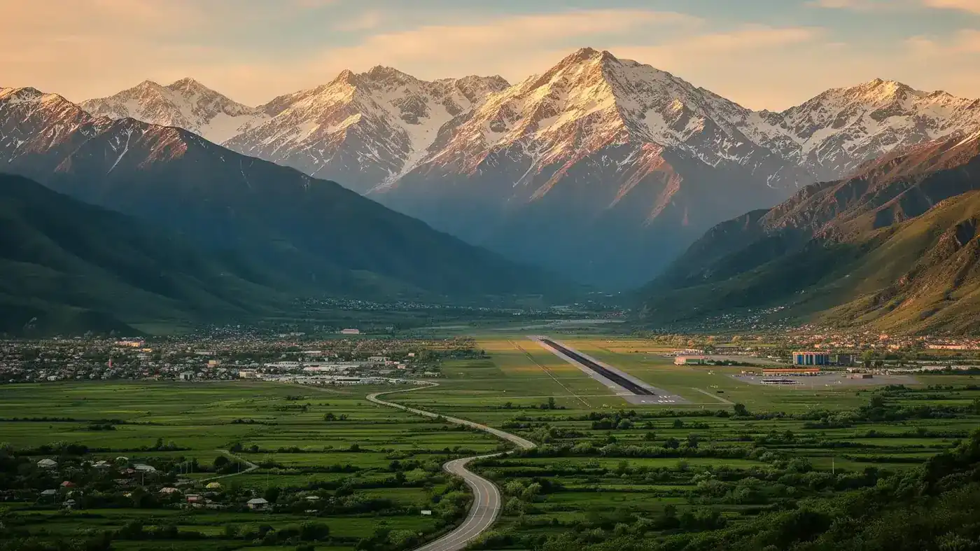 Kutaisi Airport with Caucasus mountains in the background, green valleys and a road leading into the mountains